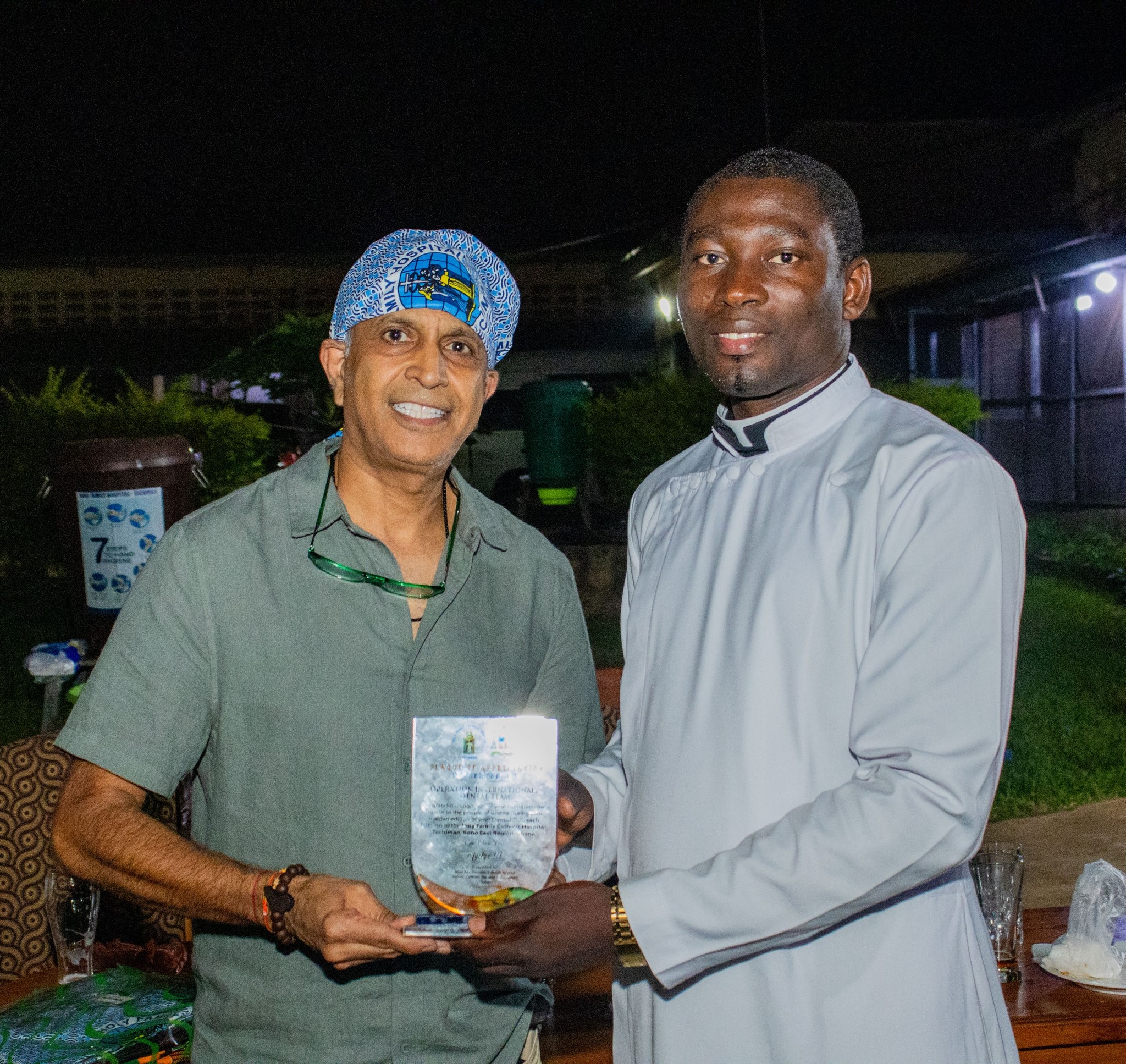 <p>Operation International Dental Team Lead receiving a plaque of appreciation from Rev. Fr. Enoch Duah (Chaplain)</p>